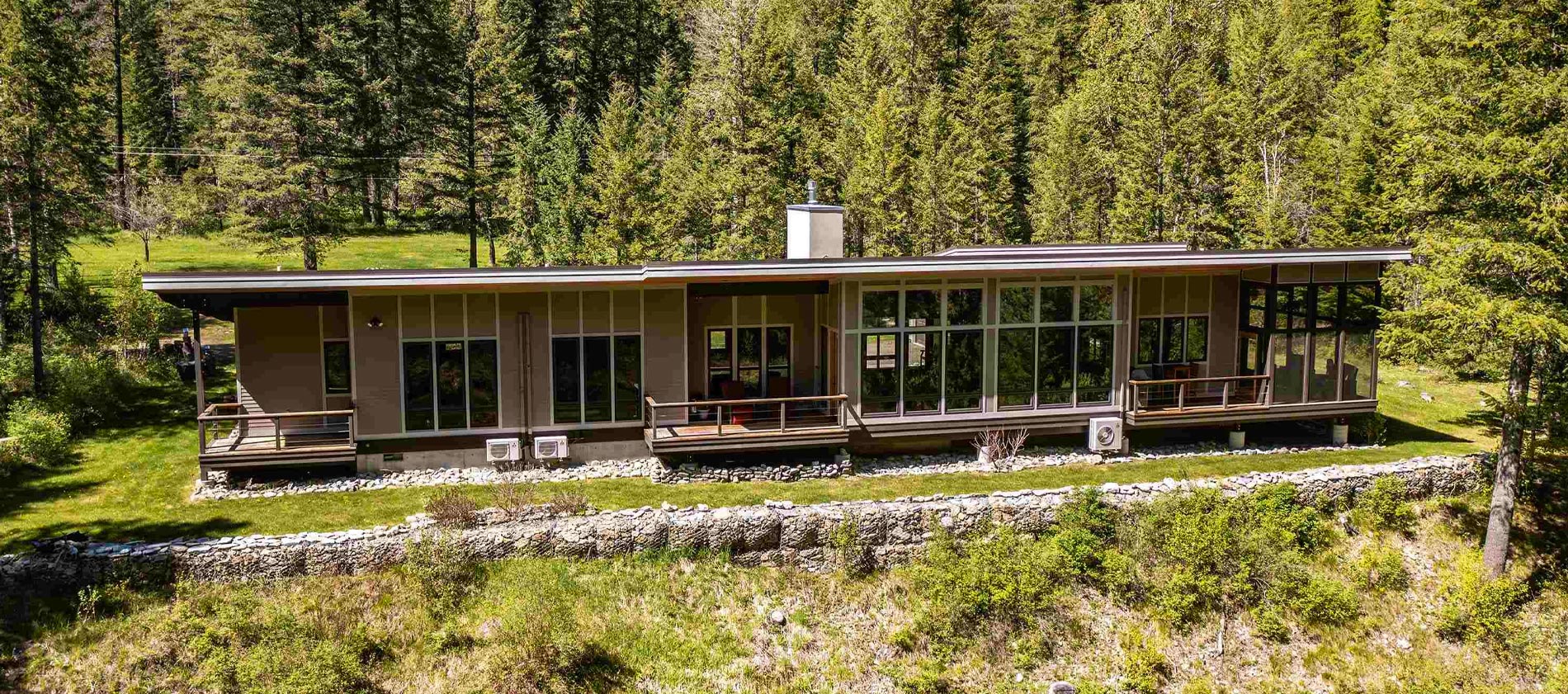 Nestled on the shores of the Bull River in a quiet and peaceful setting is an amazing custom-built home on 9.9 acres